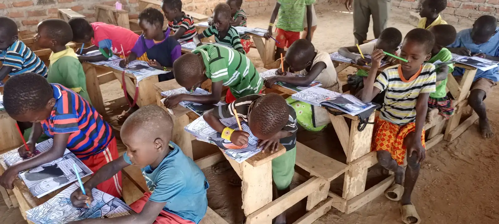 Working through the workbooks at the wooden desks